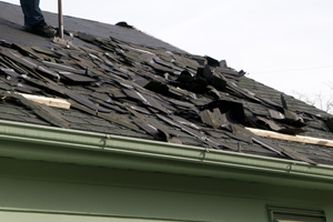 Shingles being removed from a roof for full replacement